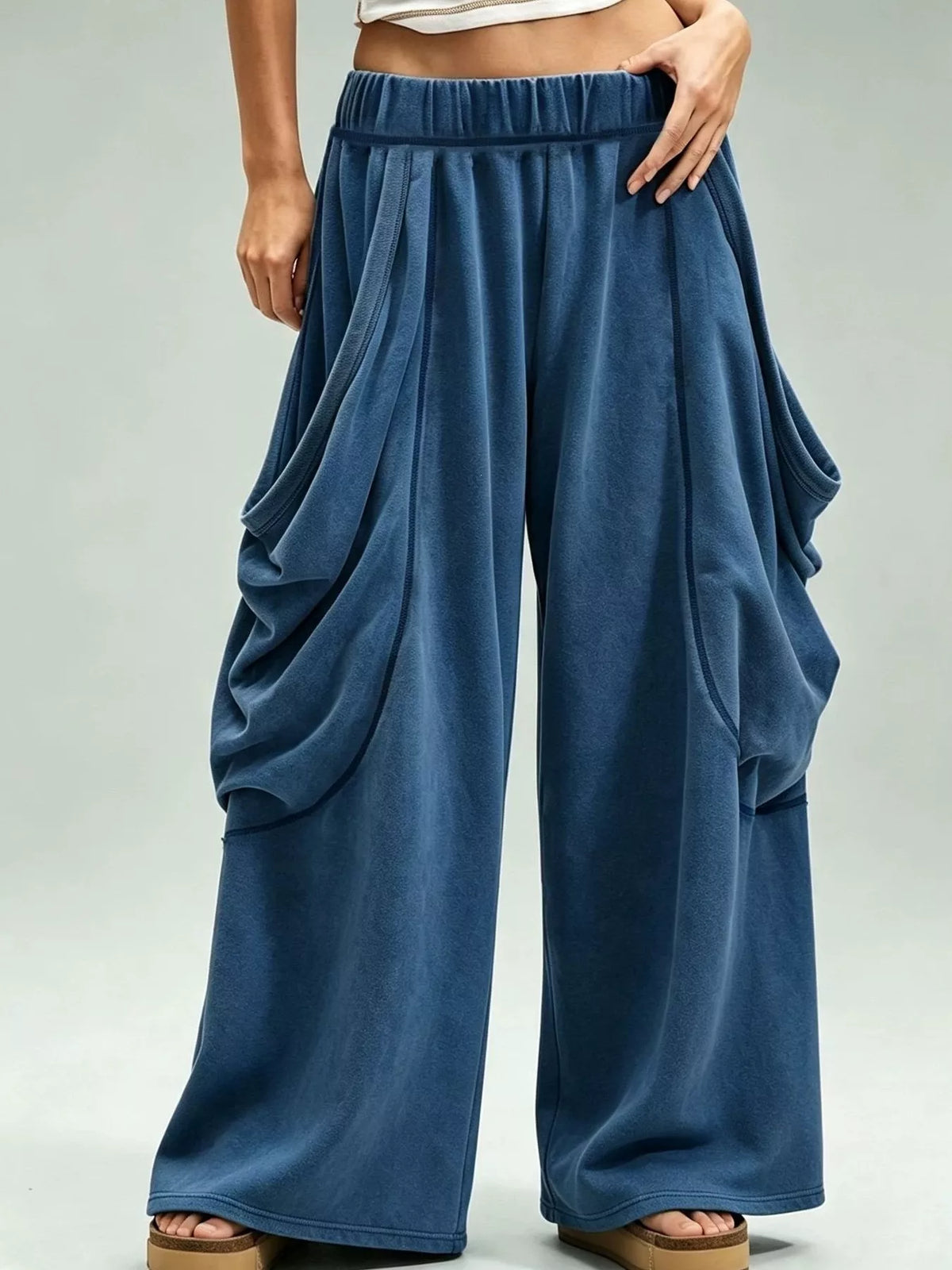 Blue wide-leg cargo pants, front view with hand at hip