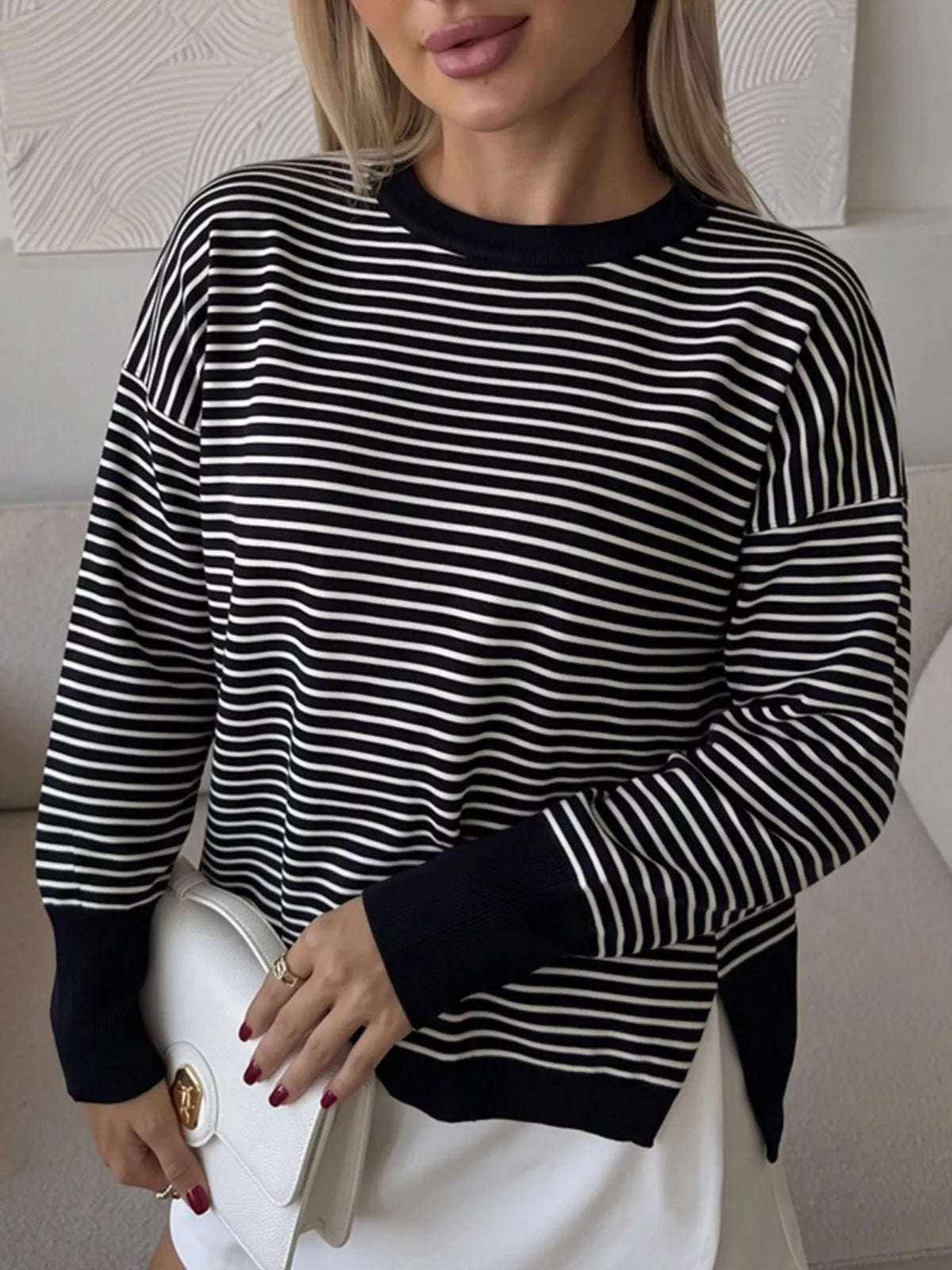 Striped round-neck knit top in black and white, standing front view