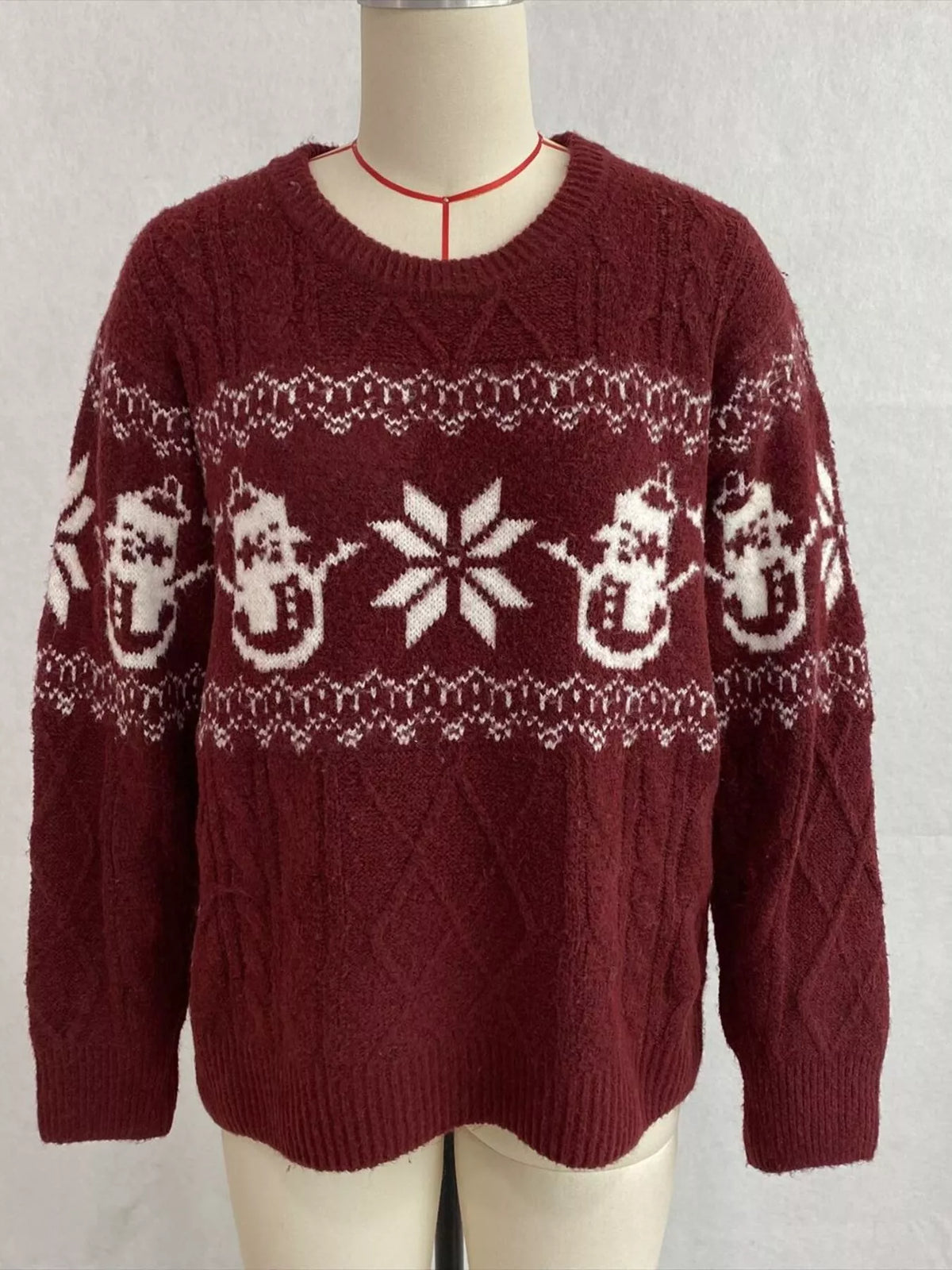 Burgundy christmas snowman cable-knit sweater, front on dress form.