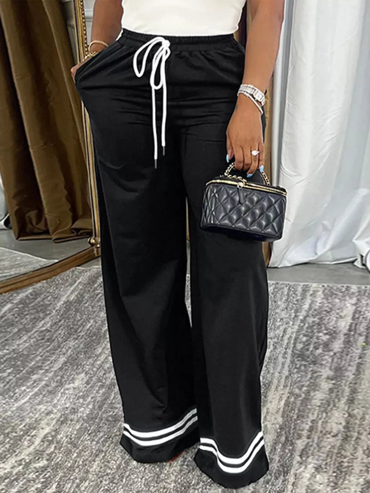 Black and white wide-leg pants with striped hems, waist and striped-hem detail