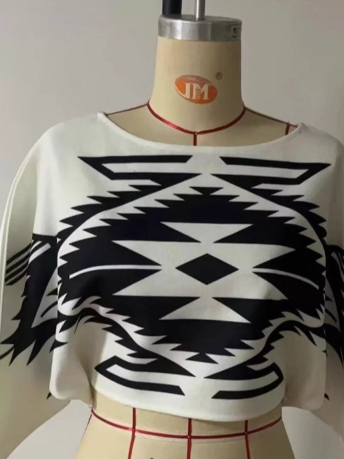 Geometric knit sweater, black and white mannequin front