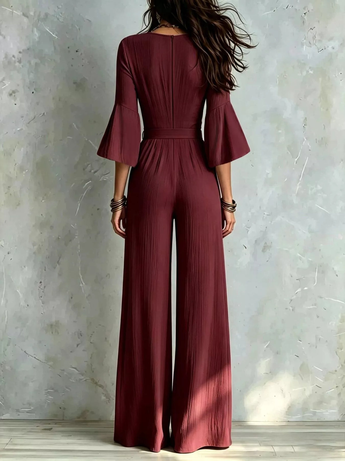 Burgundy pleated wide-leg jumpsuit with tie-waist, back view