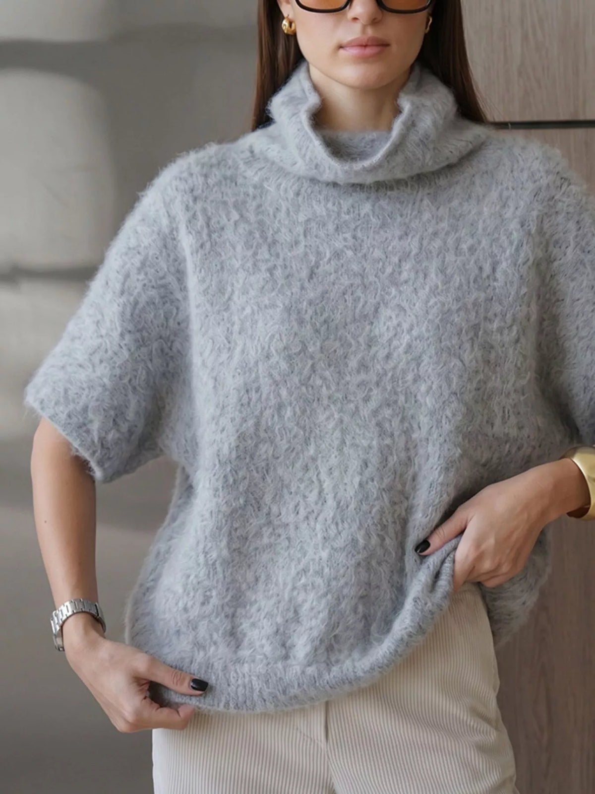 Fuzzy short-sleeve turtleneck sweater in gray, hem detail on model