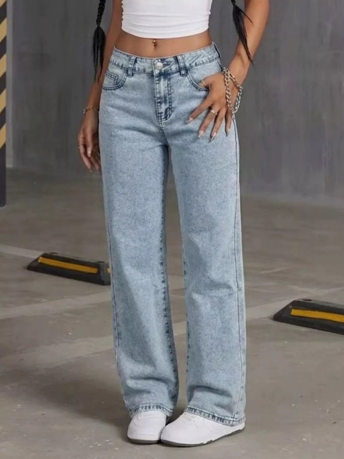 Light blue high-waisted acid-wash straight-leg jeans, front view with hand at hip.