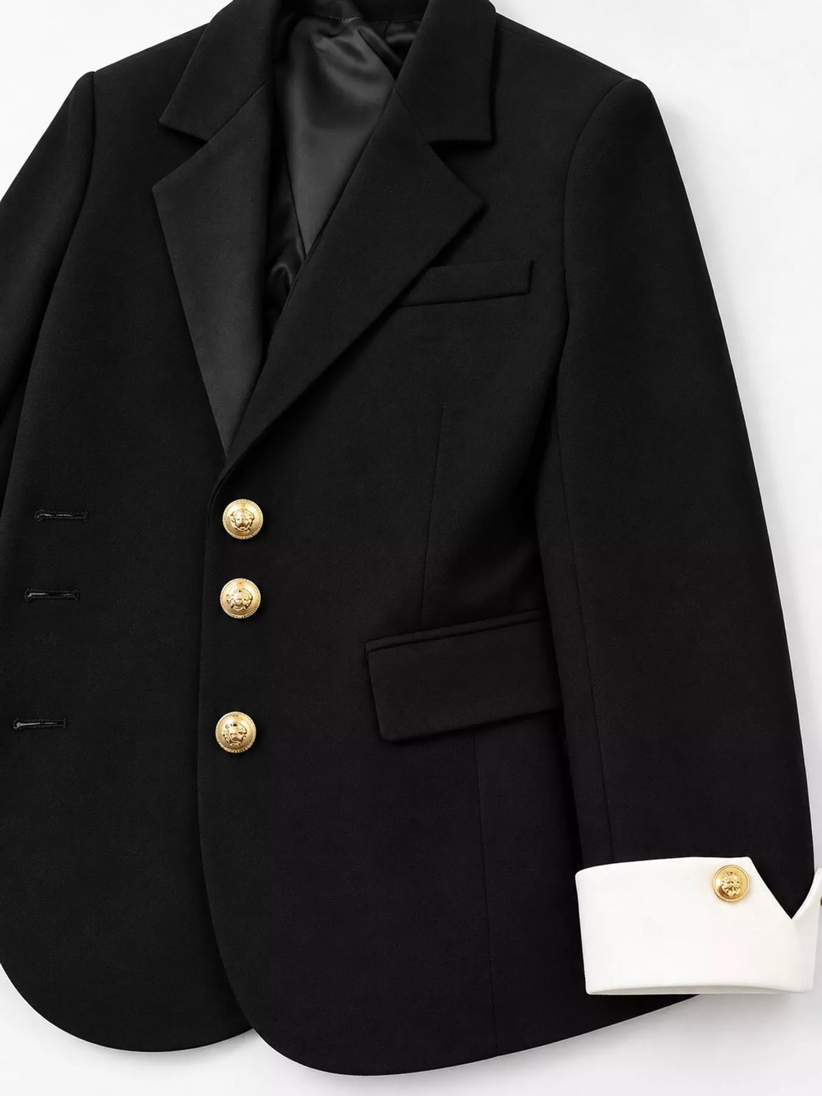 Black single-breasted blazer with gold-tone buttons, lapels, gold-tone buttons, and contrast cuffs