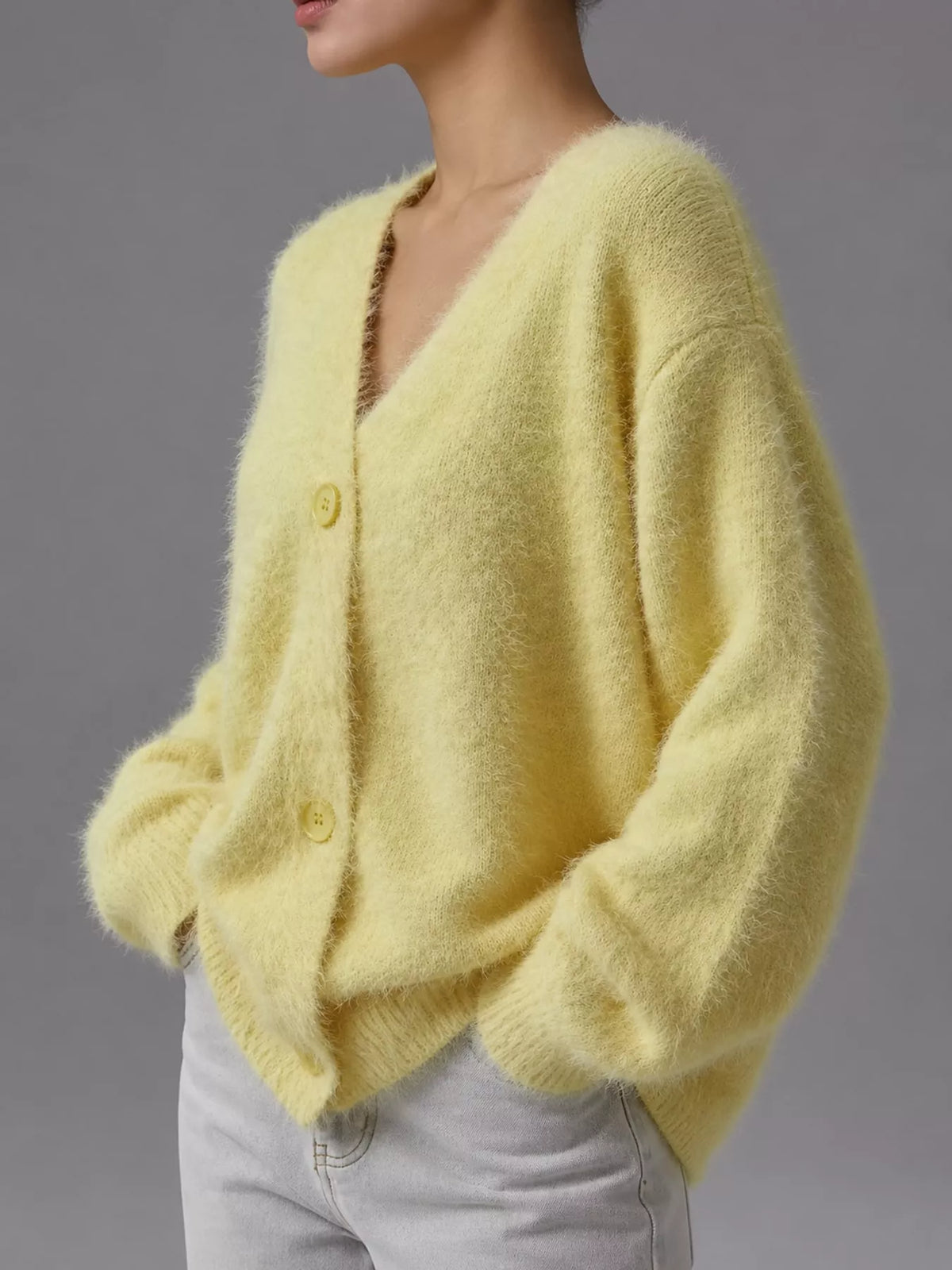 Yellow fuzzy v-neck button-down cardigan, side view