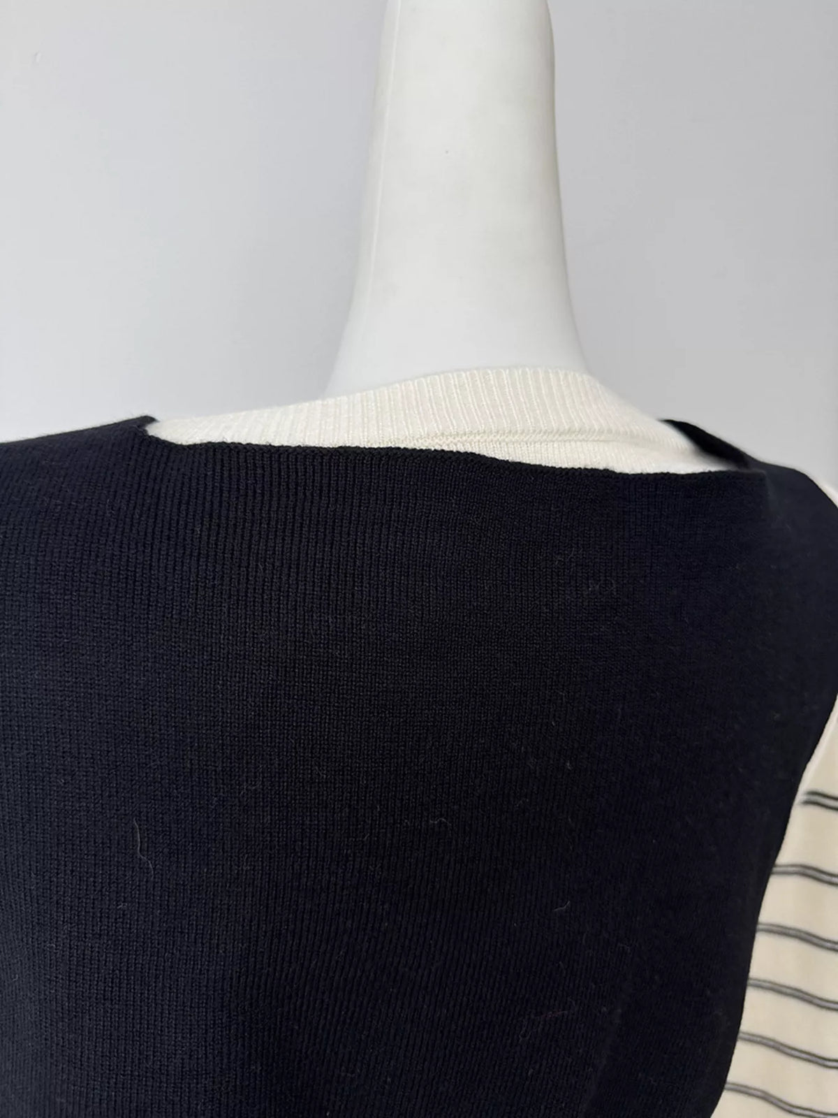 Striped crewneck sweater with layered tie detail in white and black, back shoulder detail