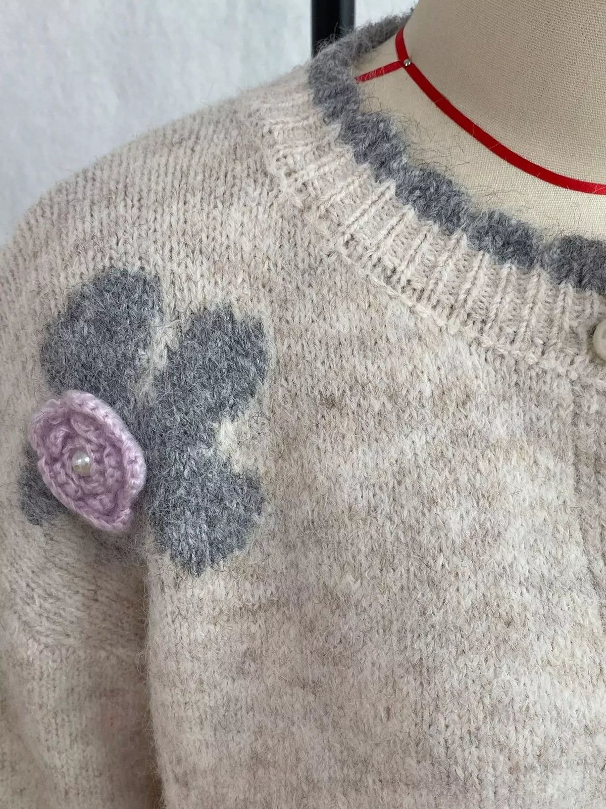 Floral-applique knit cardigan in beige, neckline and floral applique detail