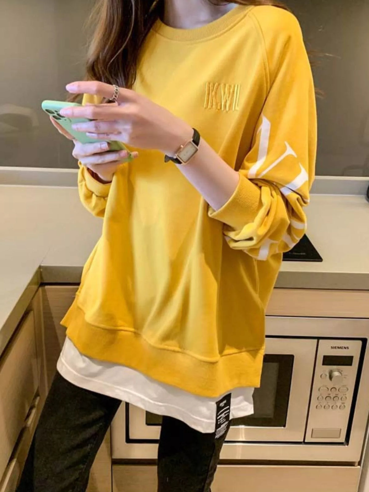 Yellow layered-hem sweatshirt with graphic sleeve detail