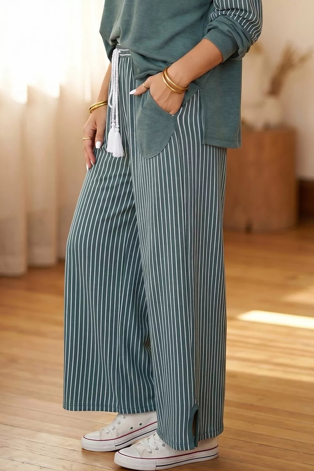 Green raw-seam top and striped pants set, side pocket and drawstring detail