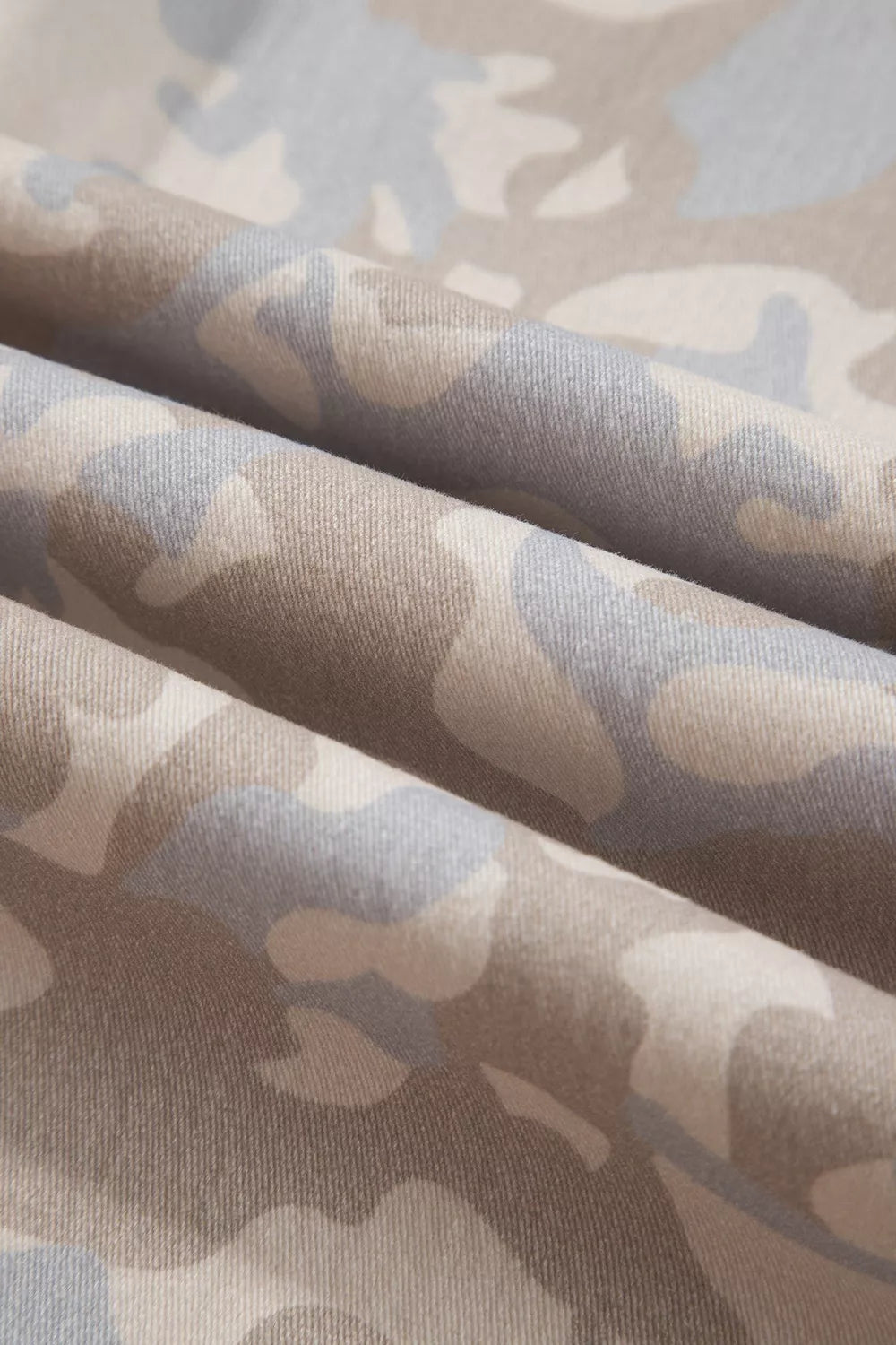 Beige camouflage barrel jeans, camouflage fabric close-up