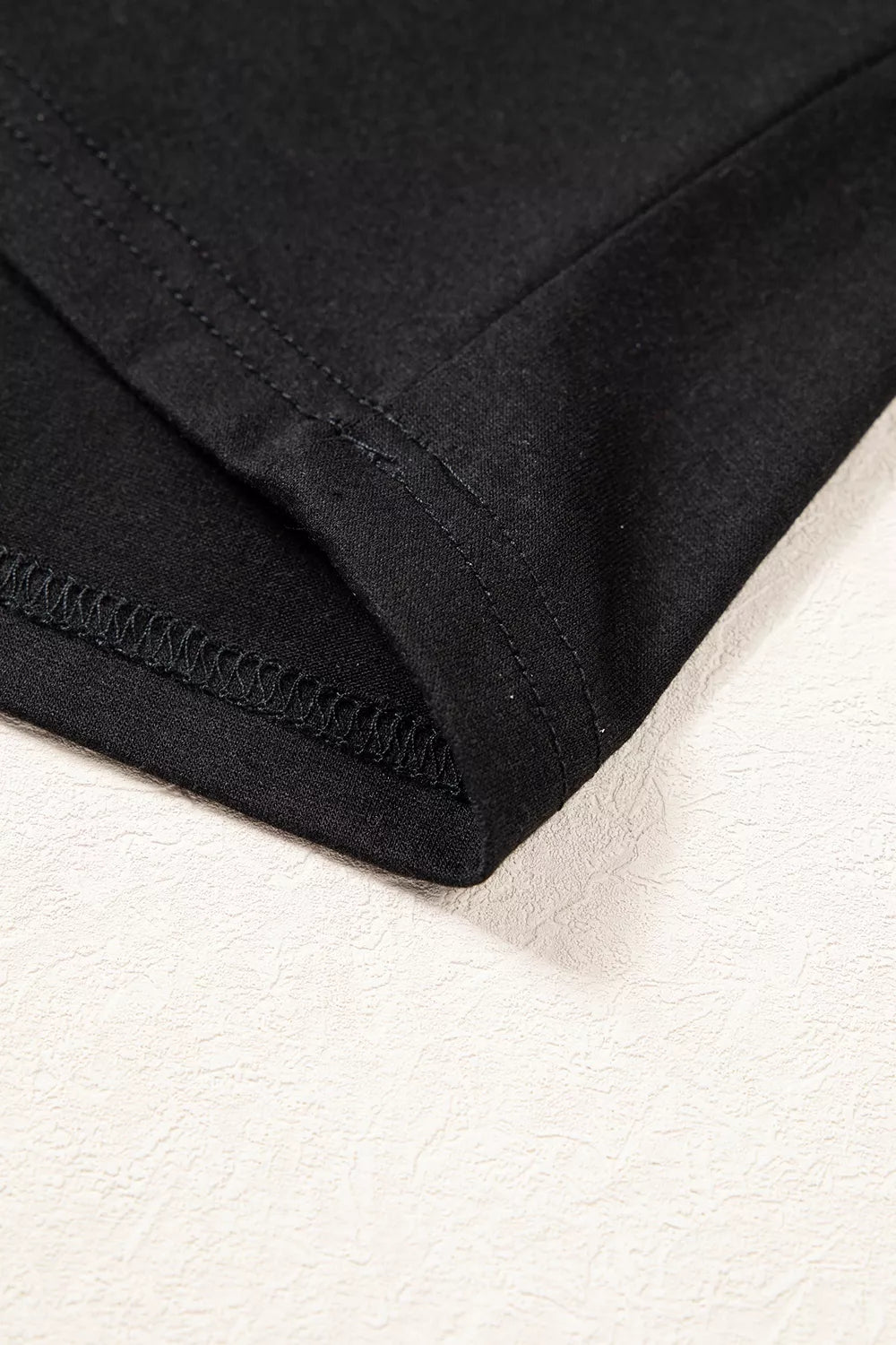 Black off-shoulder button-detail three-quarter sleeve top, hem detail