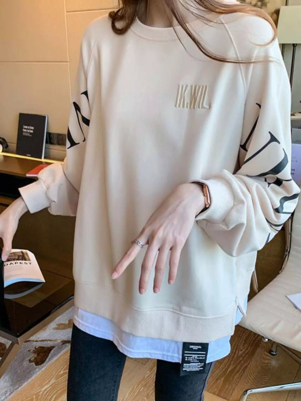 Apricot layered-hem sweatshirt with graphic sleeve detail
