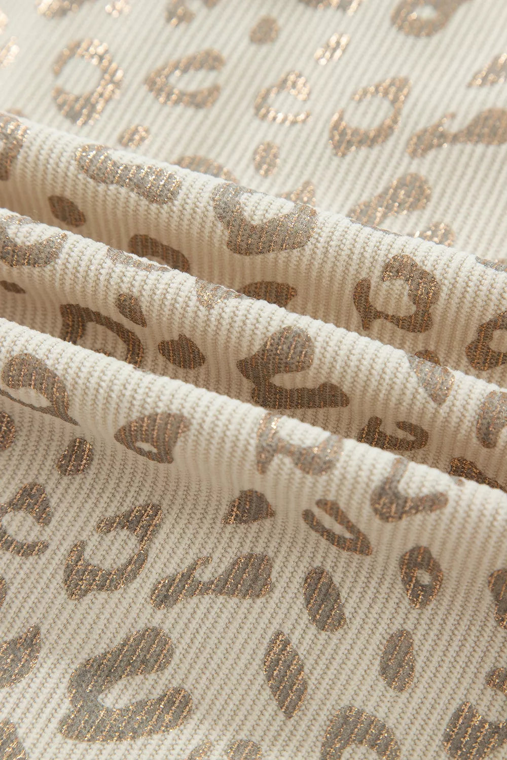 Beige leopard corduroy button-front jacket, leopard corduroy fabric close-up.