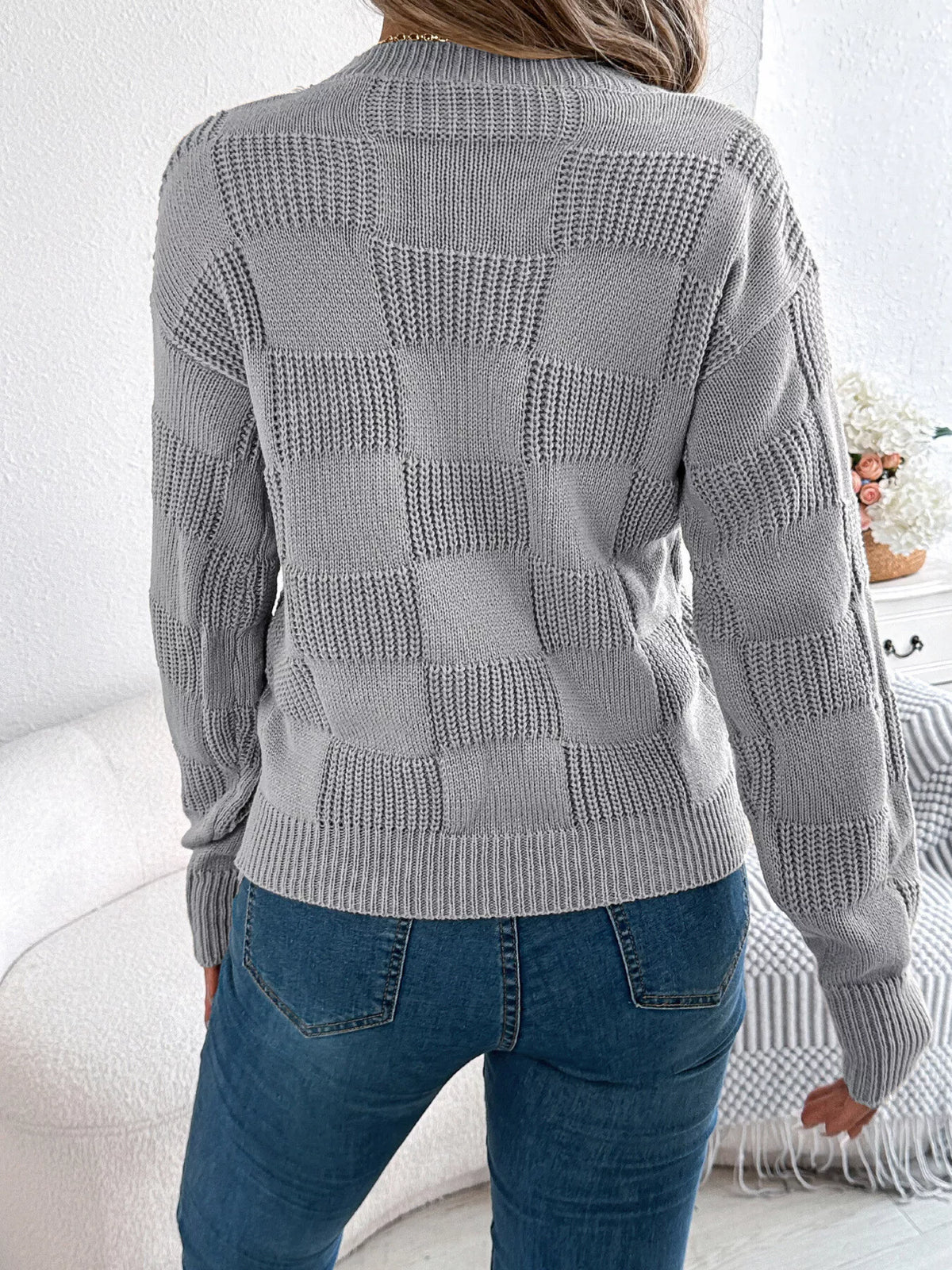 Gray checkerboard textured knit sweater, back view