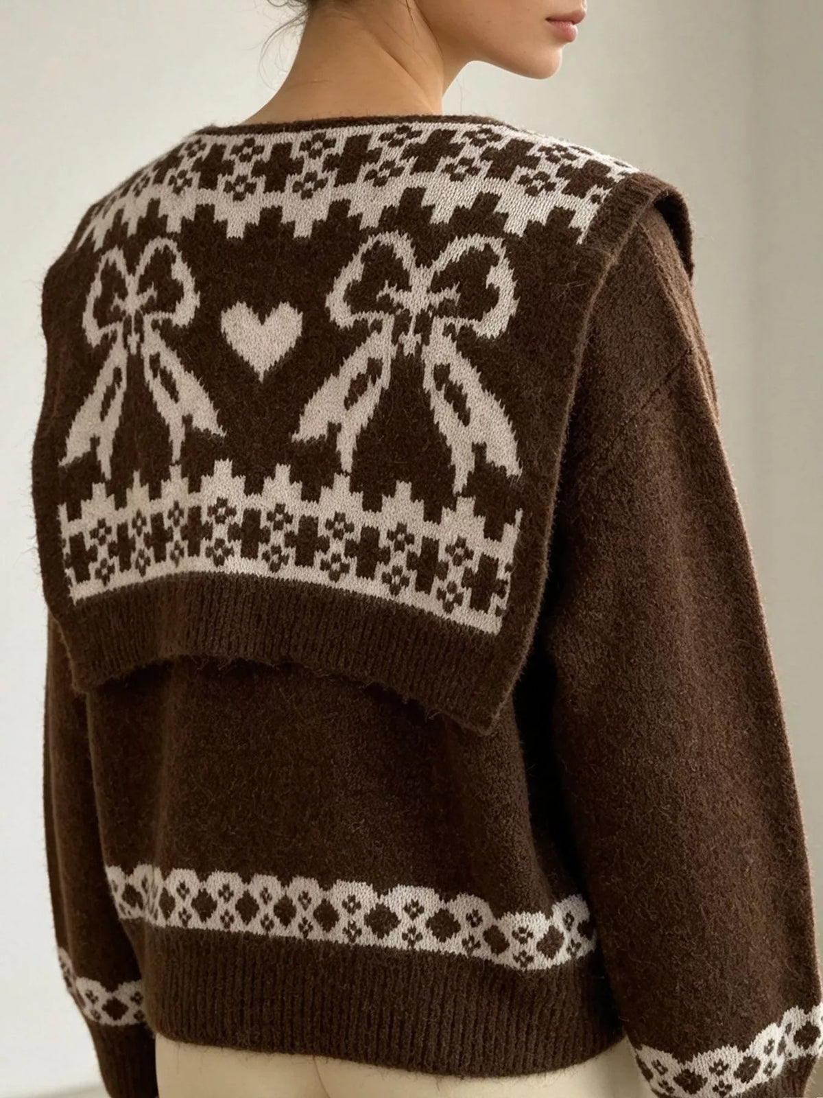 Brown scarf-detail dropped-shoulder sweater, bow-pattern scarf back view.