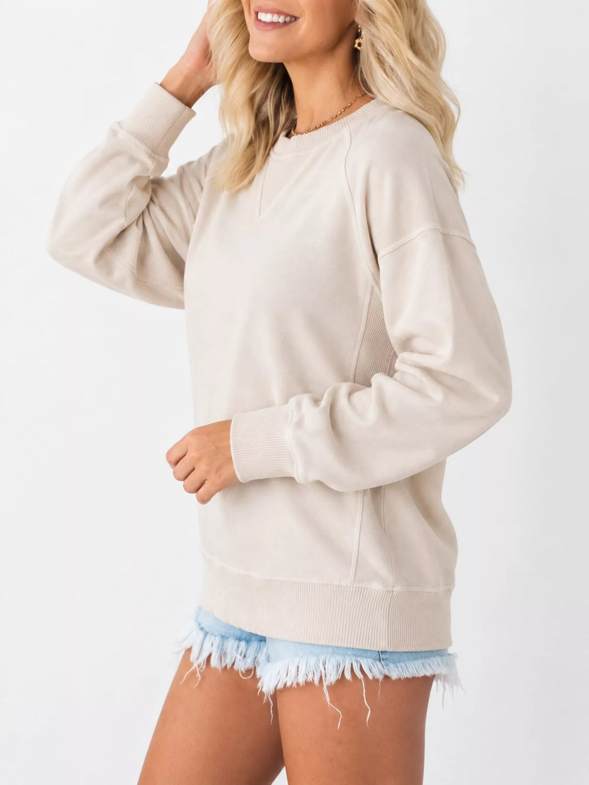 Cream crew neck raglan sleeve sweatshirt, side view