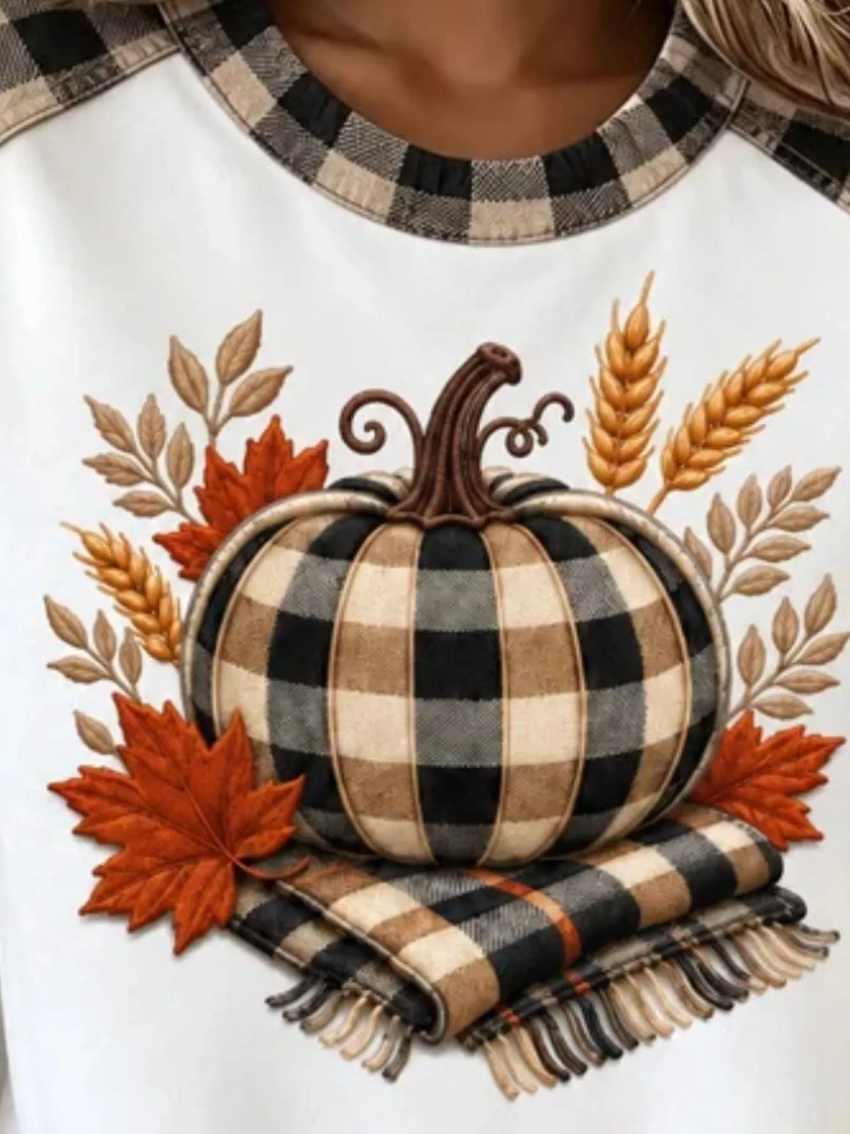 White pumpkin-patchwork sweatshirt, pumpkin graphic close-up
