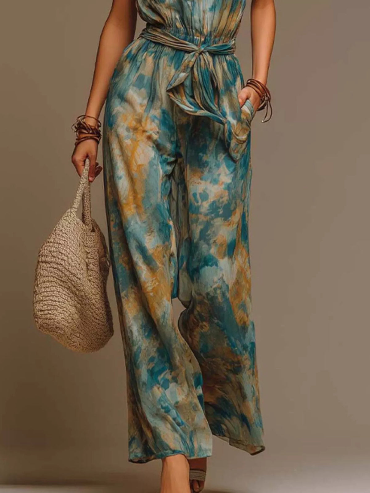 Teal tie-dye halter wide-leg jumpsuit, wide-leg pants detail.