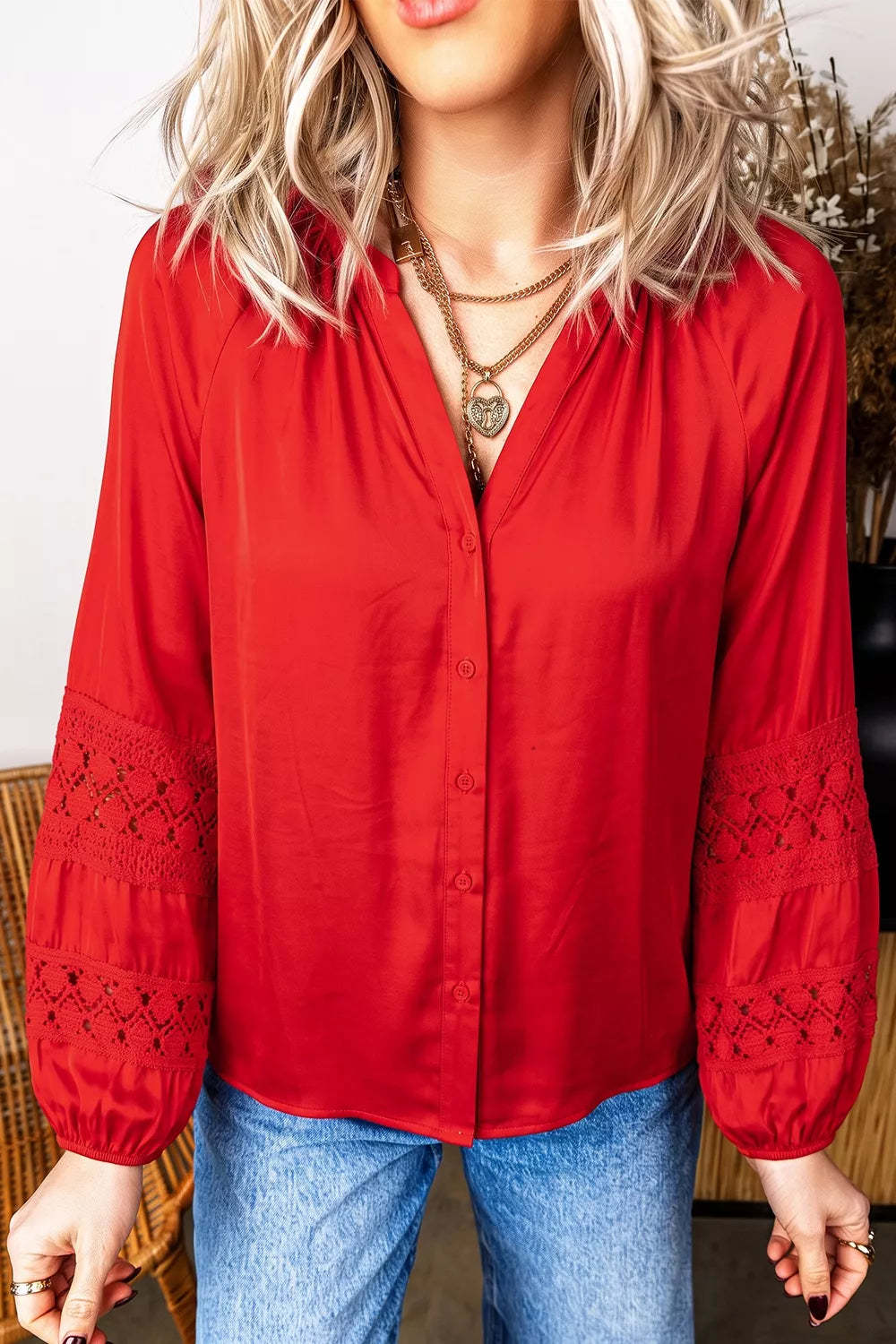 Red lace-panel v-neck button-front shirt, front with arms down.