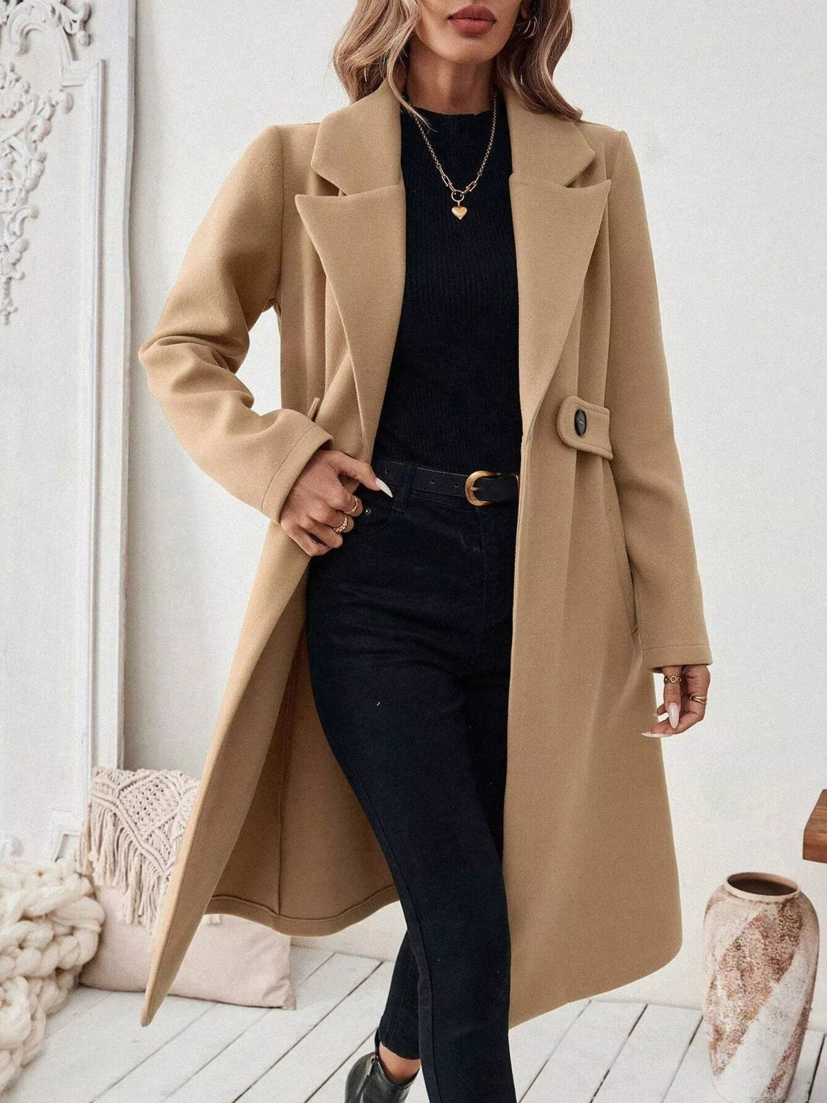 Tan lapel-collar longline coat, open front, hand at waist