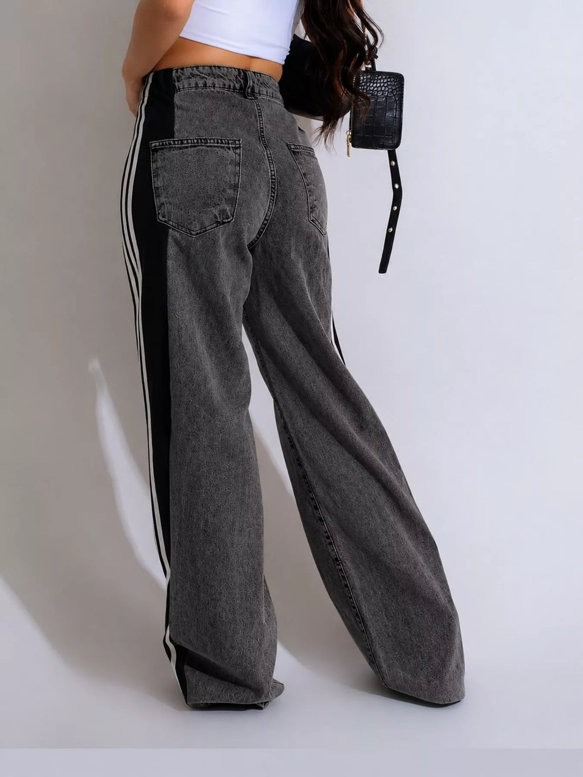 White high-waisted wide-leg jeans with side stripe detail, back view
