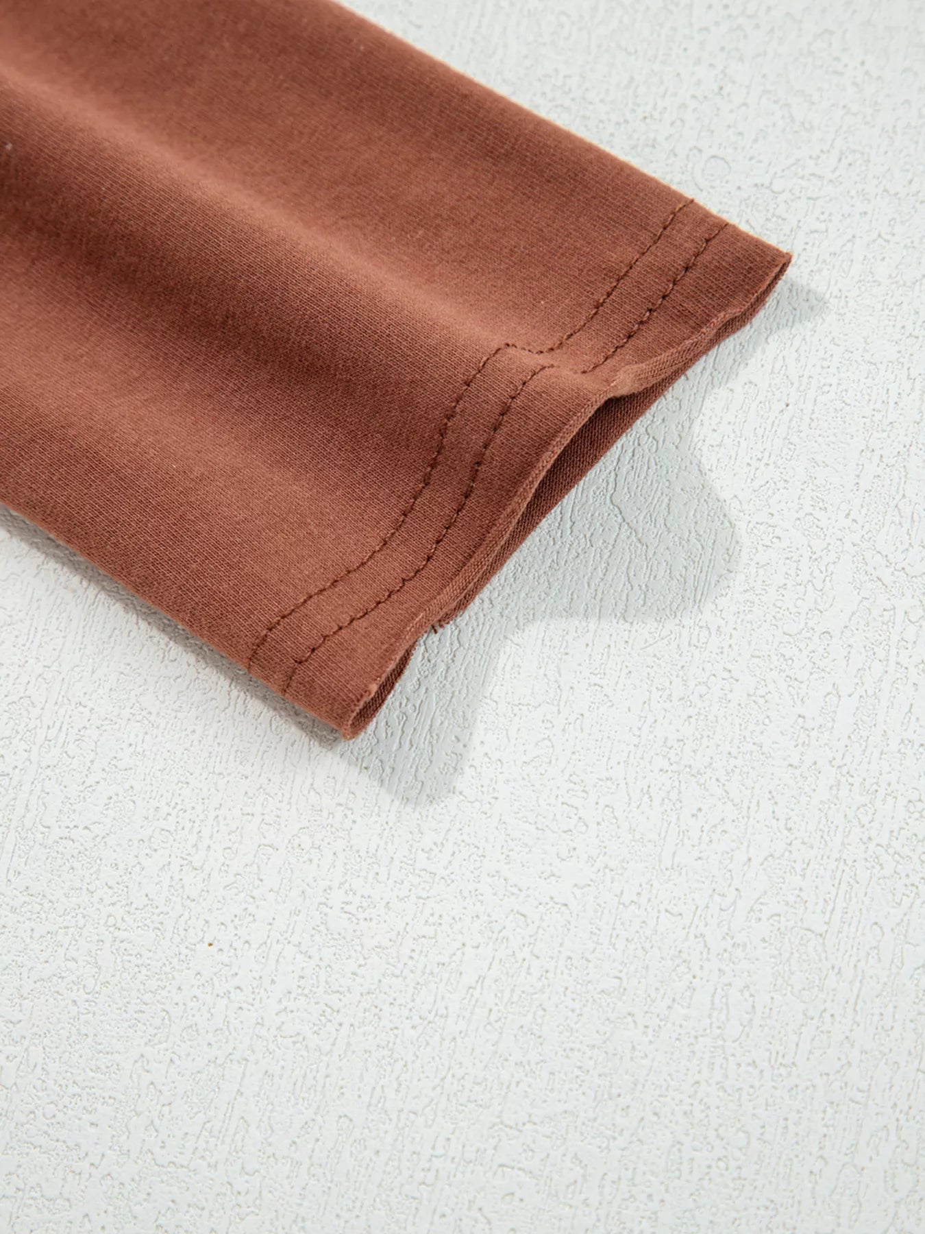 Trendsi Raw Seam Detail Solid Color Long Sleeve Top -