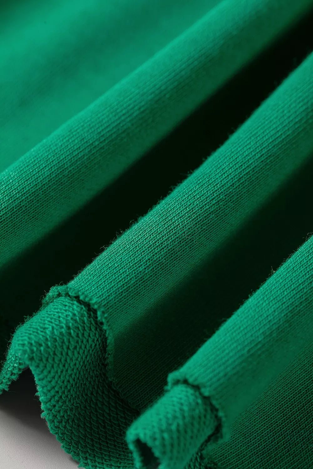 Green hooded top and wide-leg pants set, raw hem detail