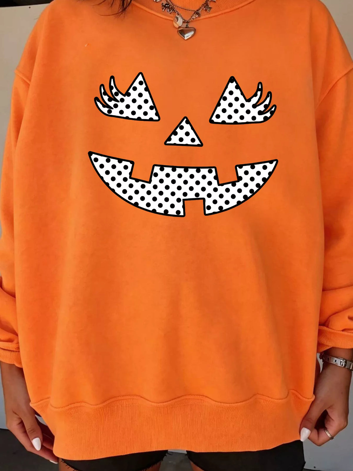 Women's Polka Dot Pumpkin Face Halloween Graphic Pullover Sweatshirt in Orange, back view