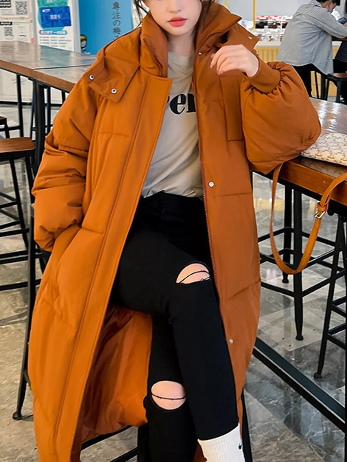 Longline puffer coat, orange seated front