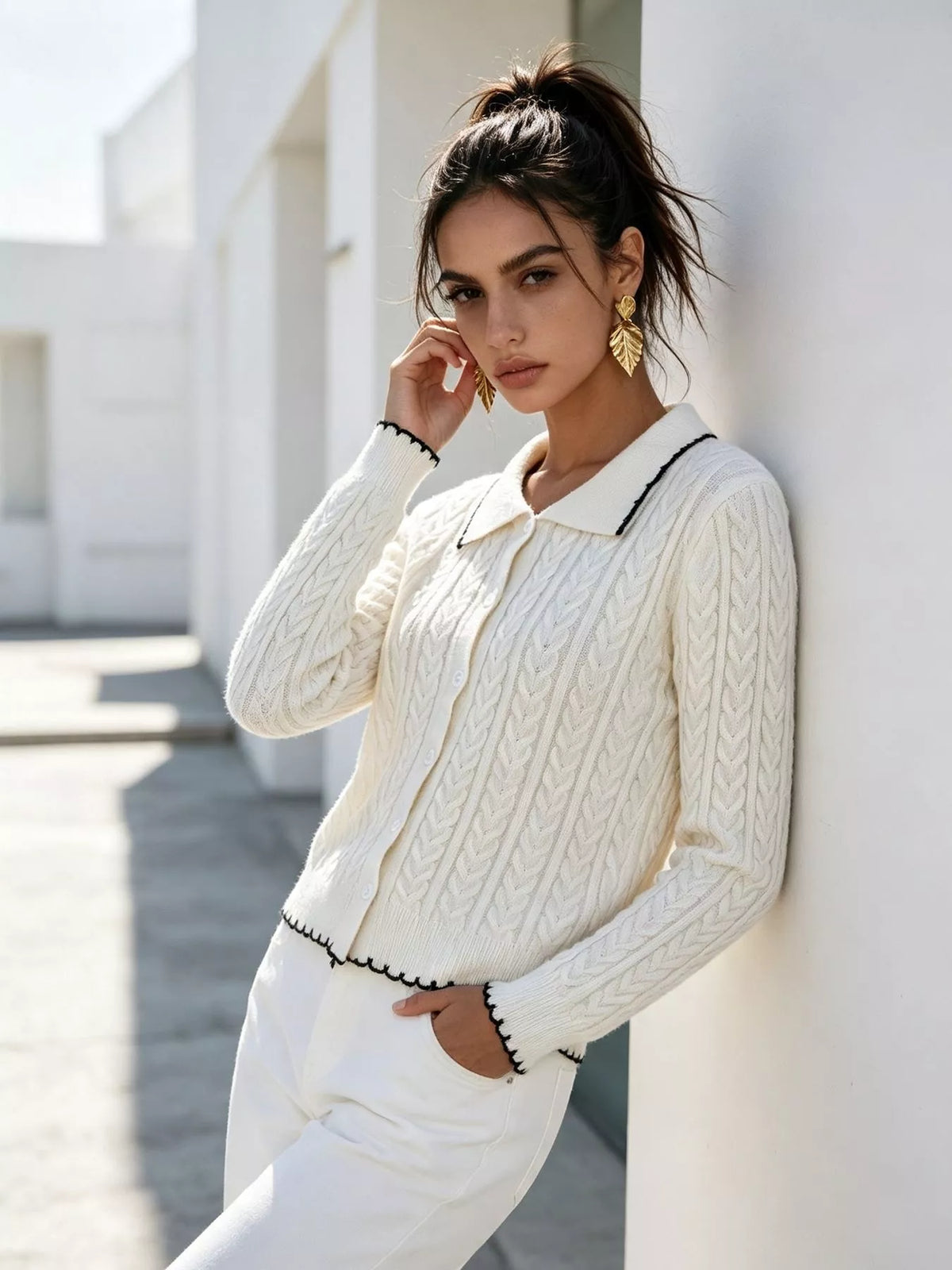 Ivory cable-knit polo-collar cardigan, angled front view.