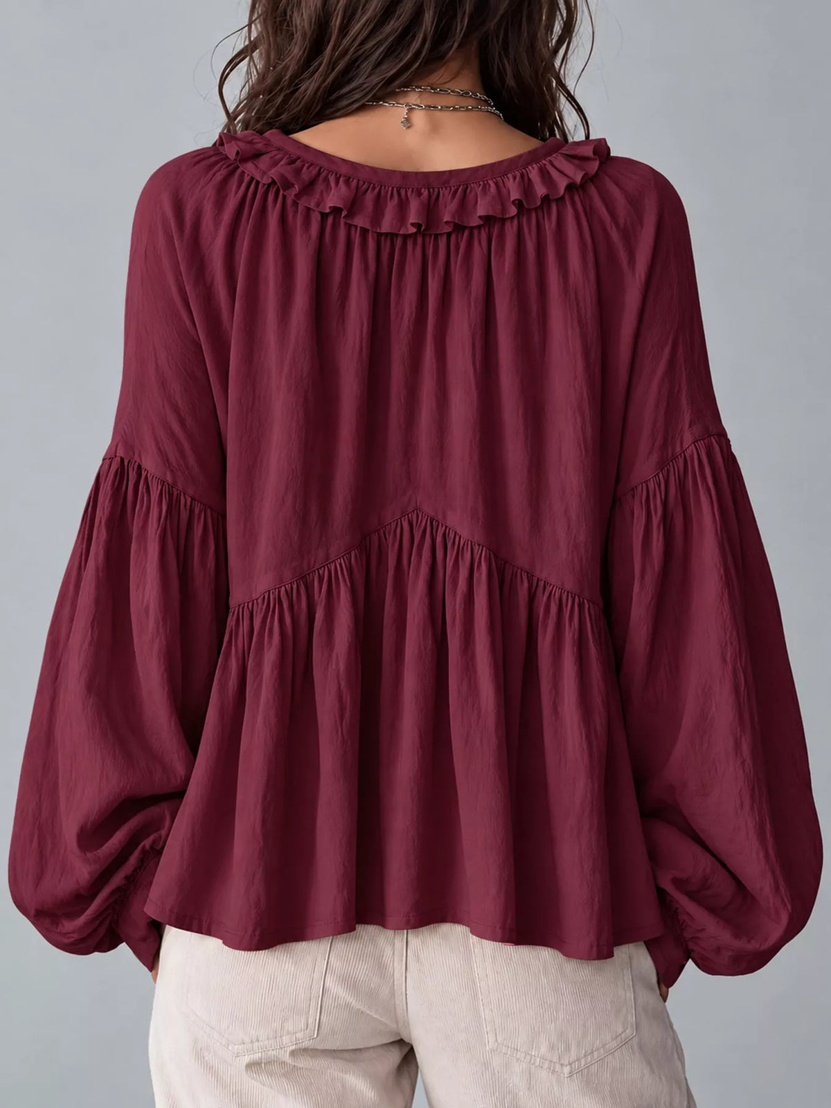 Burgundy ruffled v neck blouse, back view