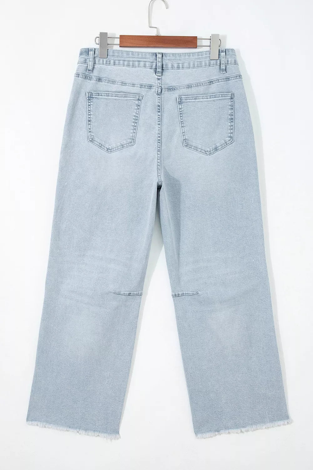 Light blue sequin turkey raw-hem ankle jeans, back on hanger.