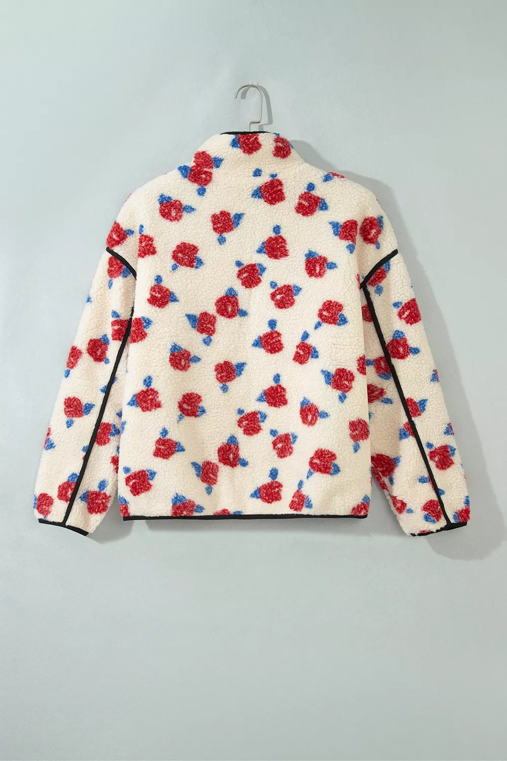 Cream with red flowers floral zip-up fleece jacket, back on hanger.
