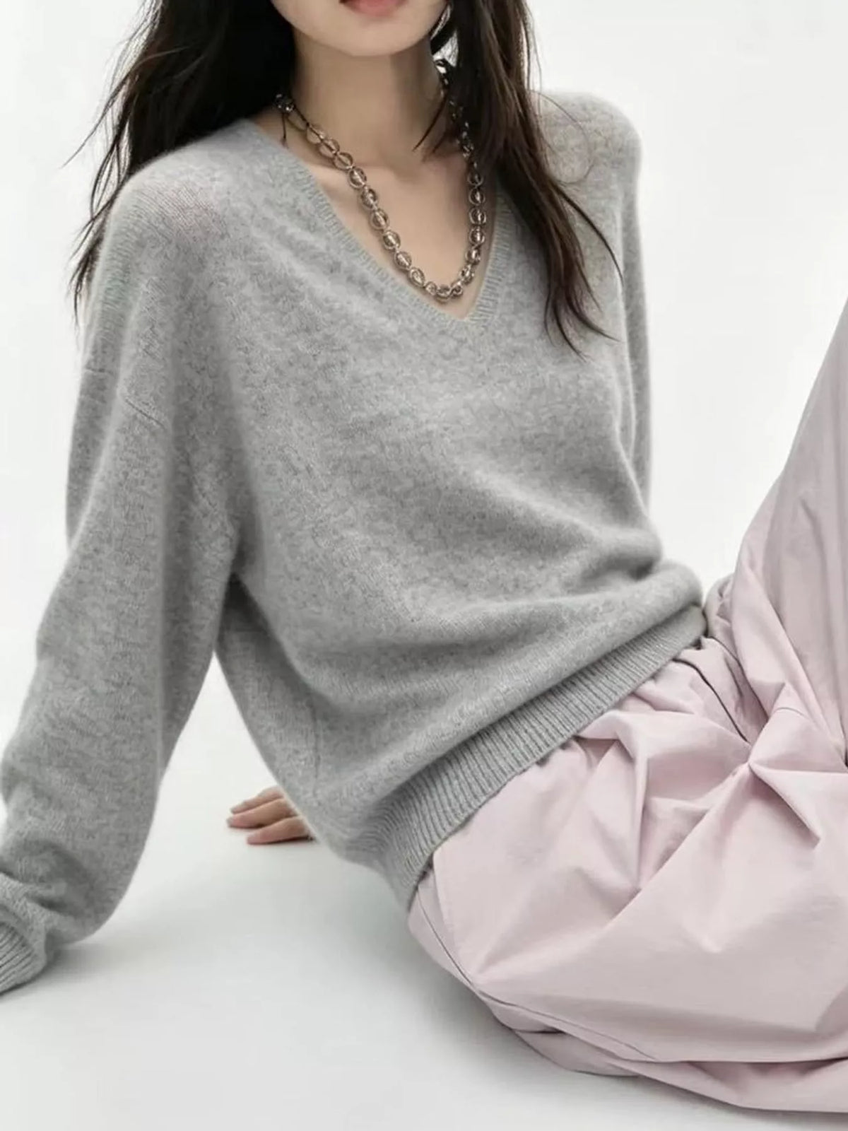 Light gray v-neck sweater, V-neckline, sleeve, and ribbed hem