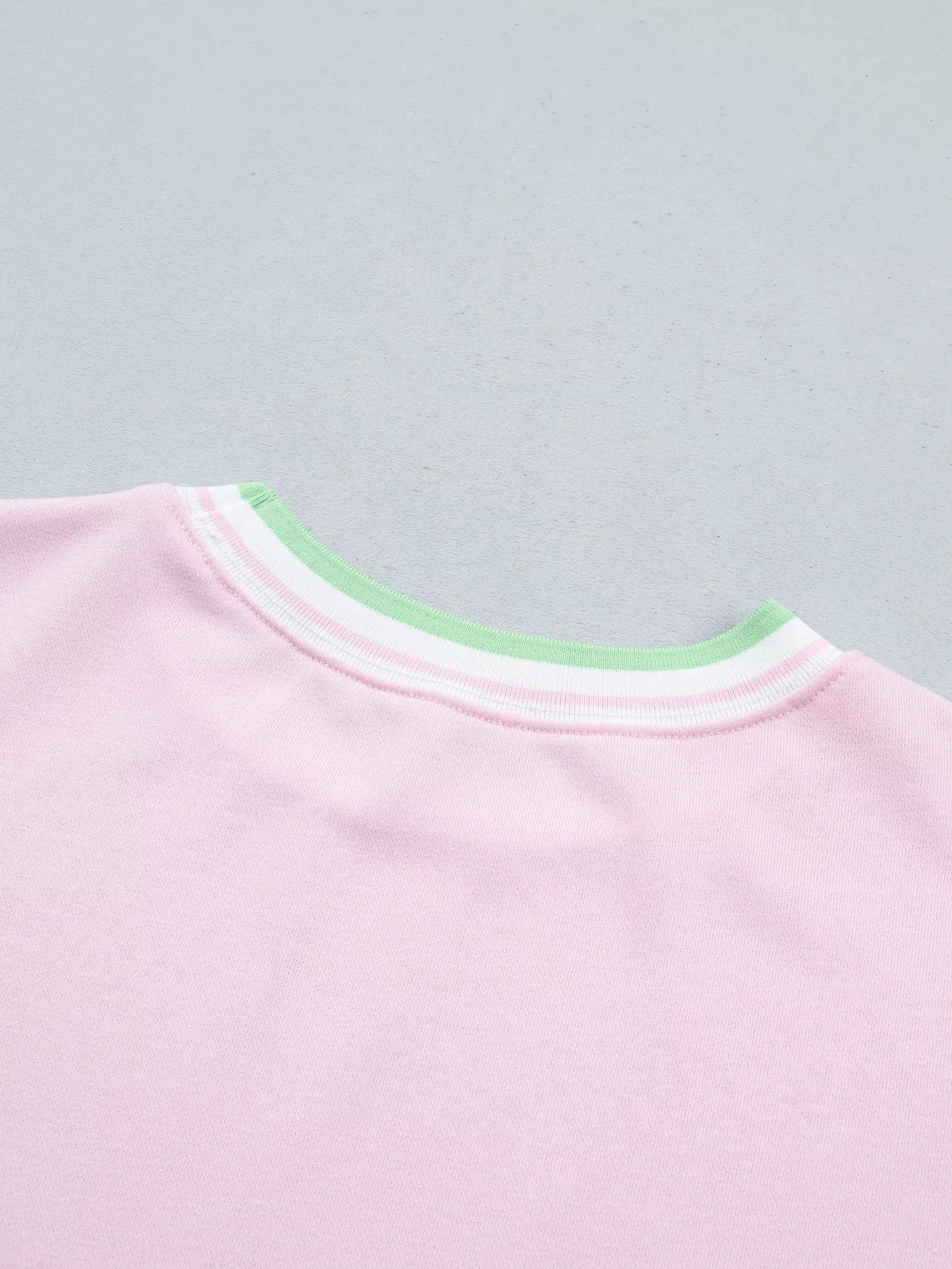 Pink sweatshirt with contrast striped ribbed trim, back neckline detail