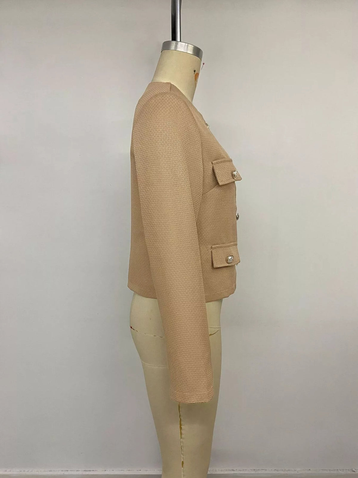 Tan textured cropped jacket with gold-tone buttons, side on mannequin