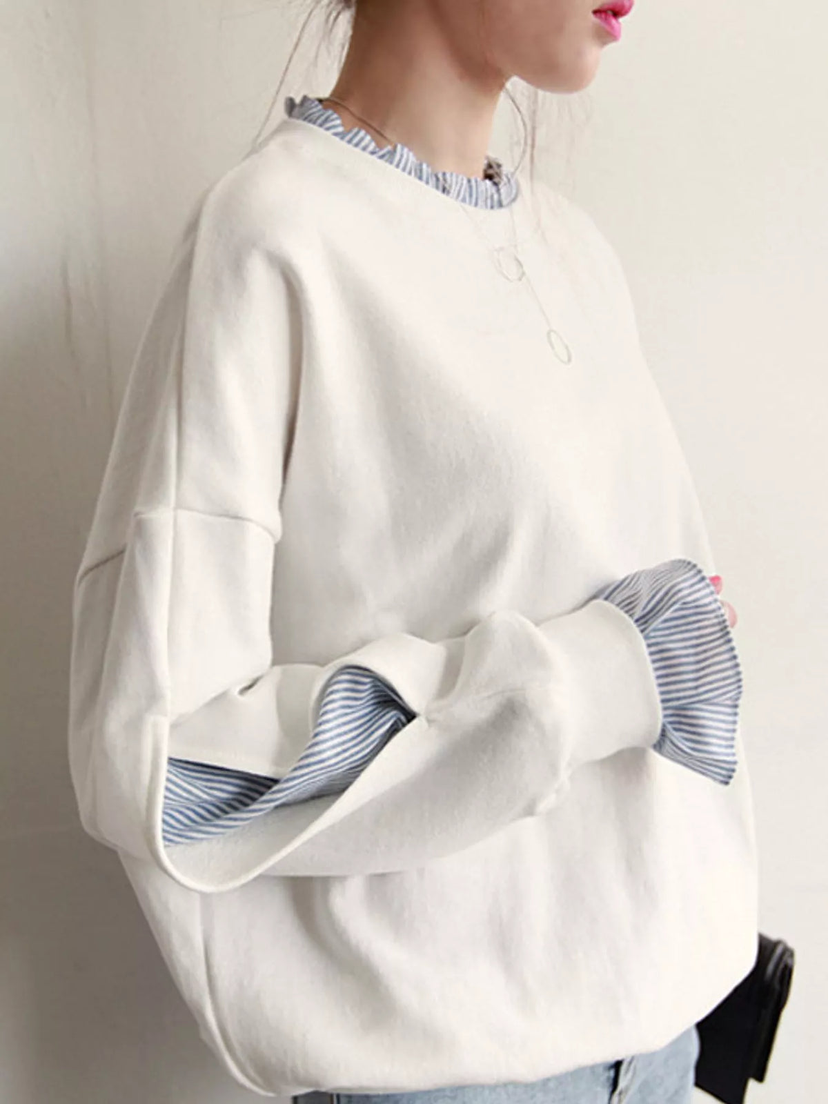 White crewneck sweatshirt with striped ruffle cuffs