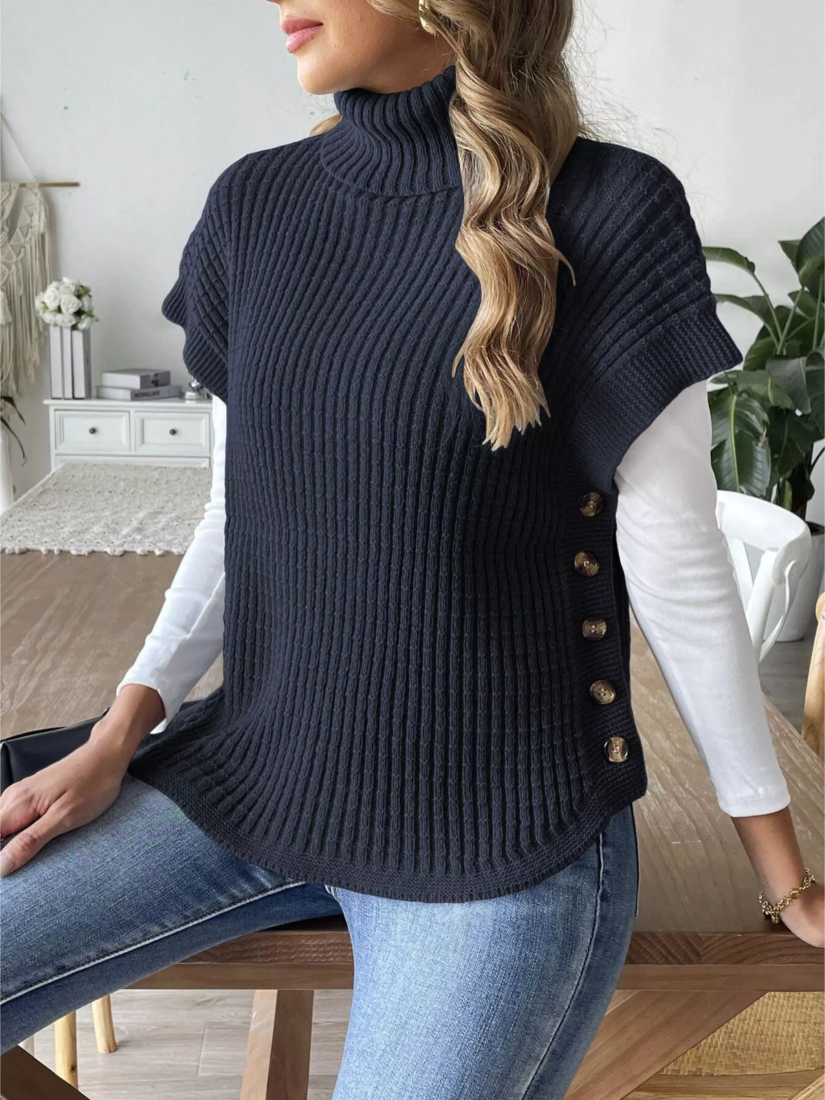 Navy ribbed turtleneck side-button sweater, angled view showing side buttons.