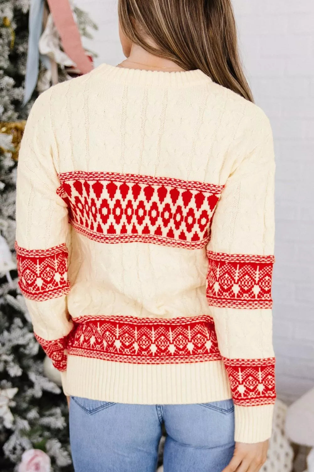 Ivory geometric cable-knit crewneck sweater, back view.