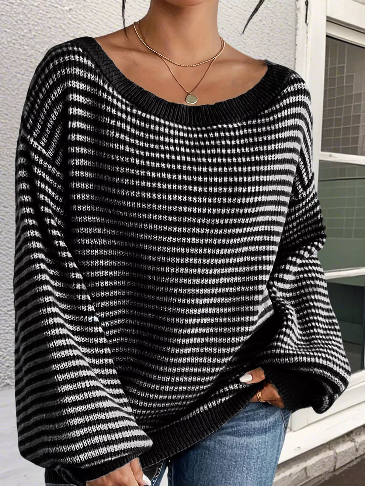 Black and white striped knit boat neck sweater