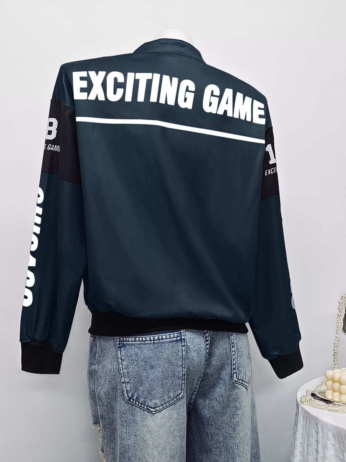 Navy and white letter-print zip-front jacket, back on mannequin