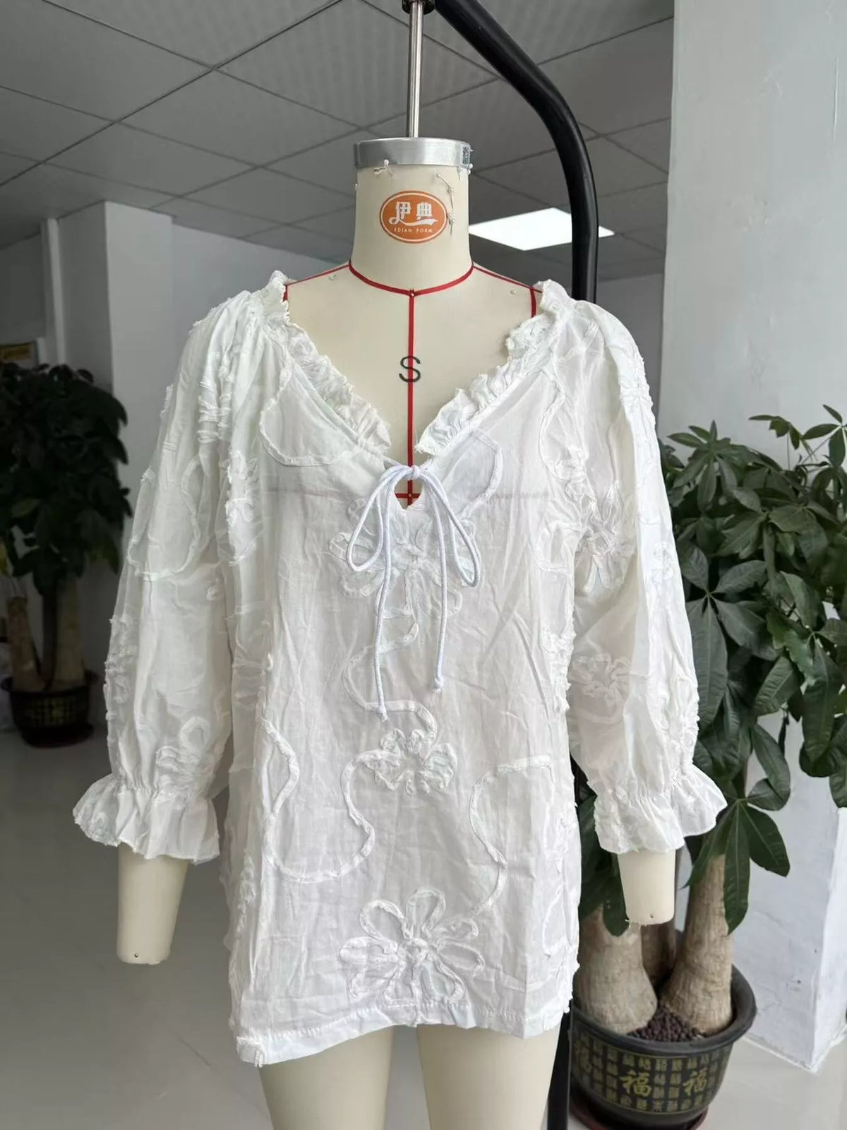 Floral Tie Neck 3/4 Sleeve Blouse in white, front on dress form view