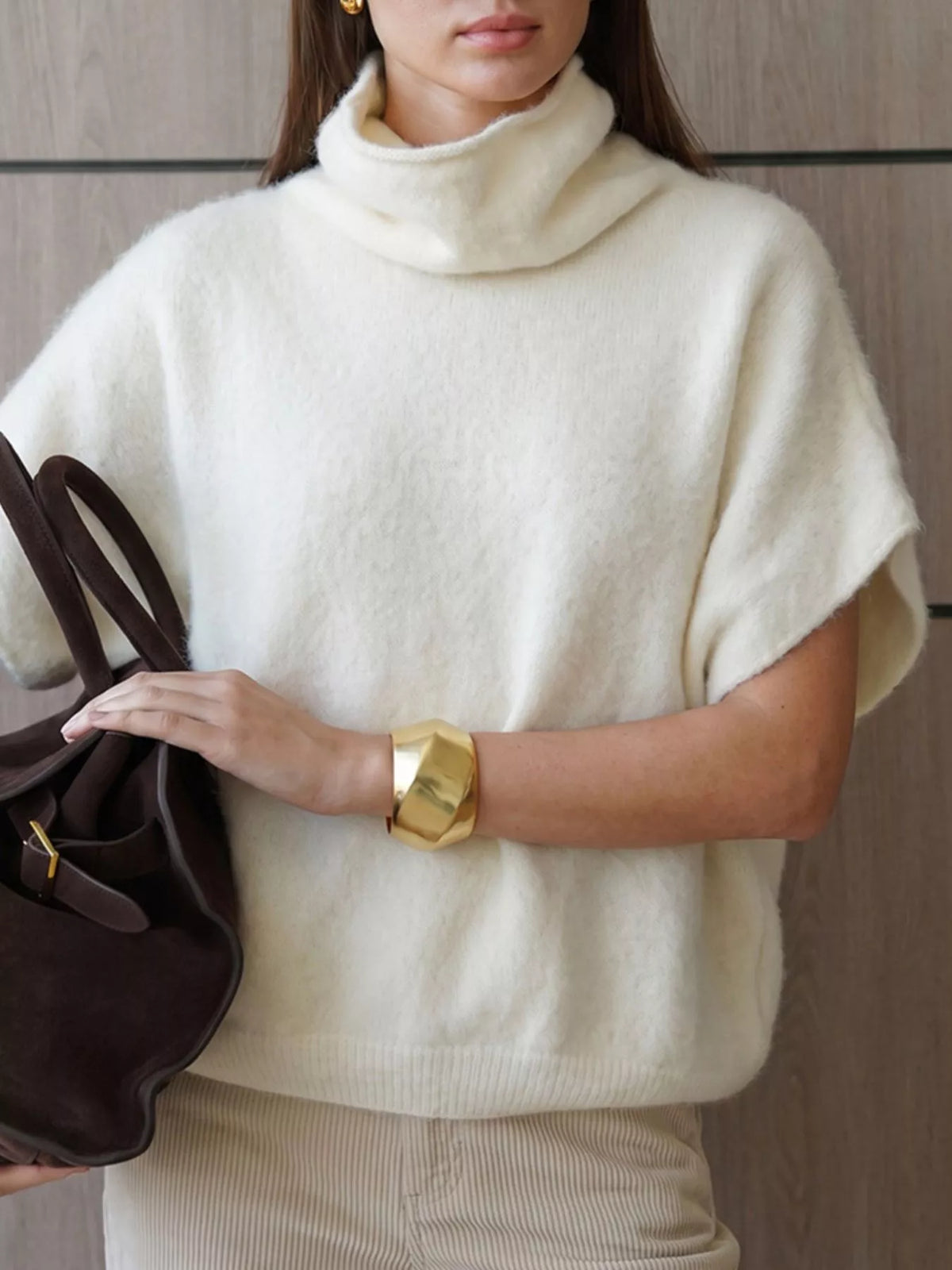 Fuzzy short-sleeve turtleneck sweater in cream, crossed-arm front view