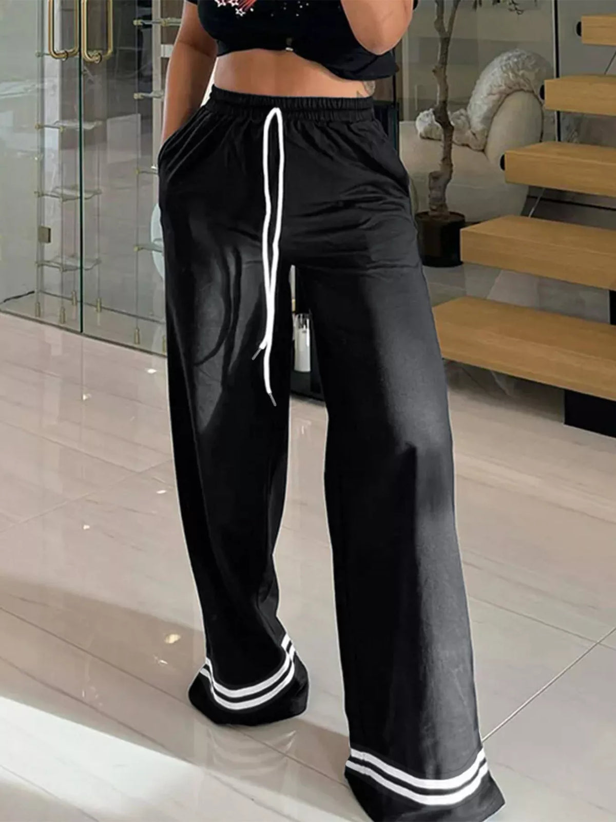 Black and white wide-leg pants with striped hems, front view