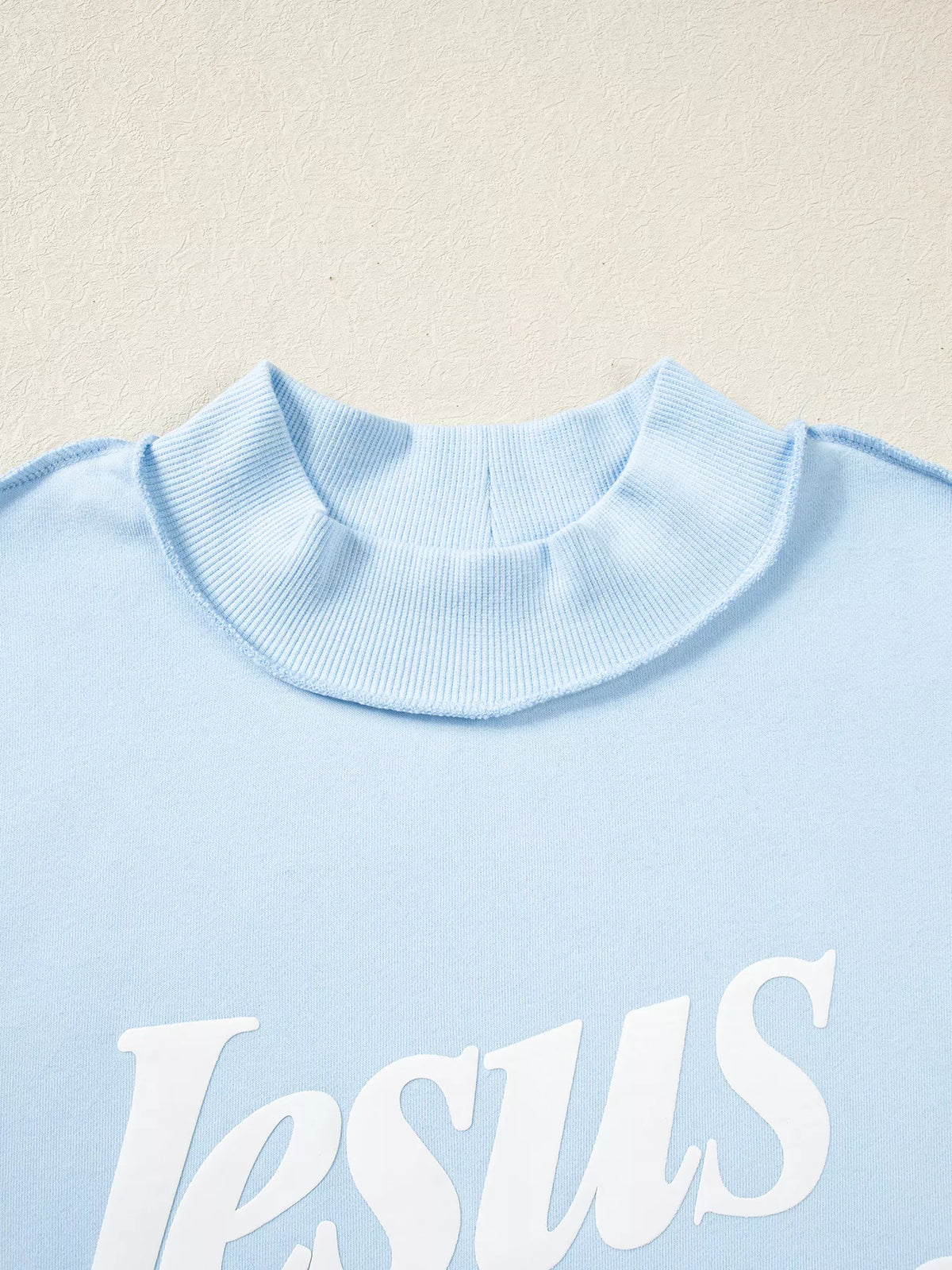 Jesus Saves lettering on light blue jesus saves stand neck oversized sweatshirt