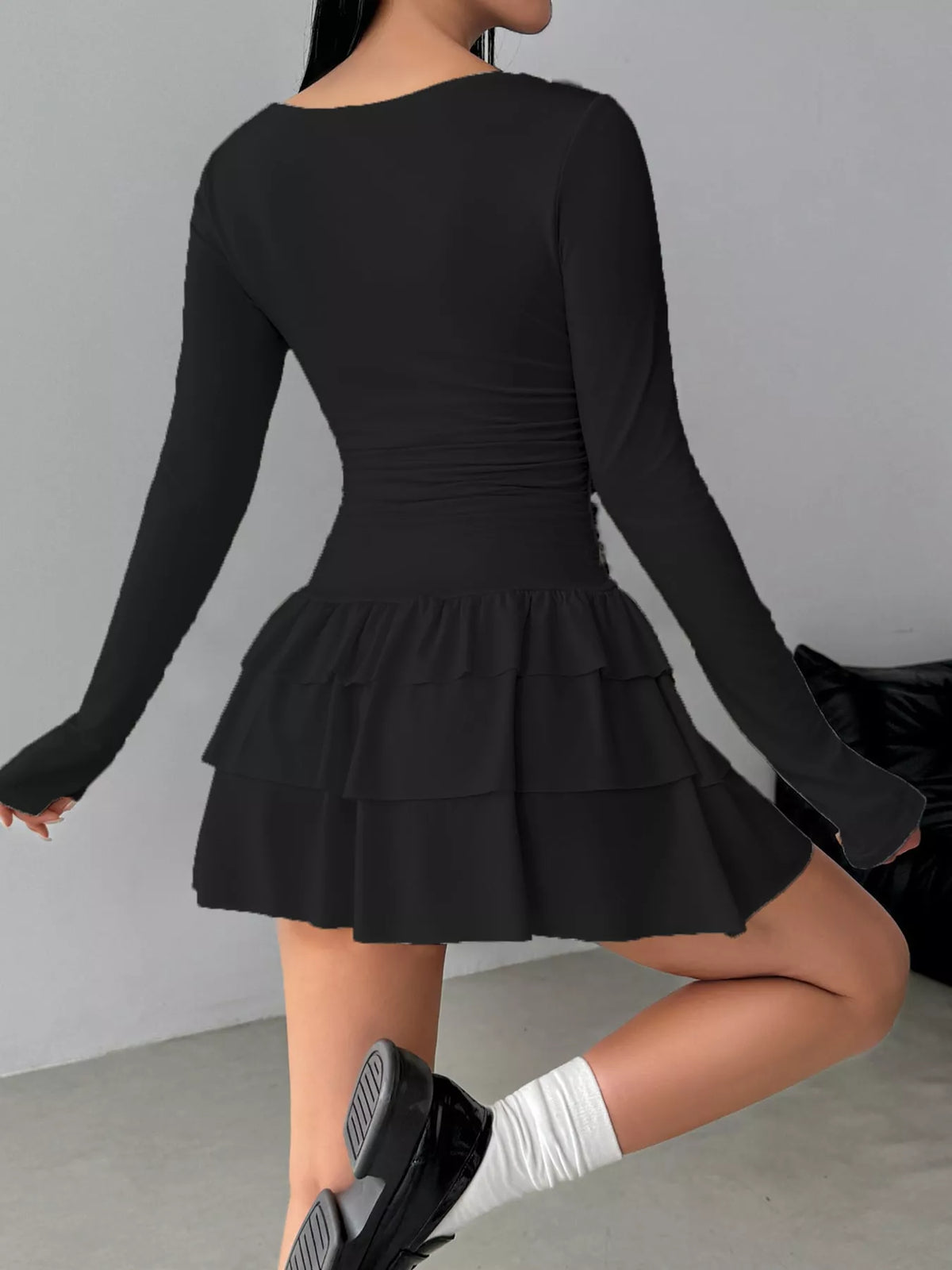 Black layered ruffle mini dress, back view