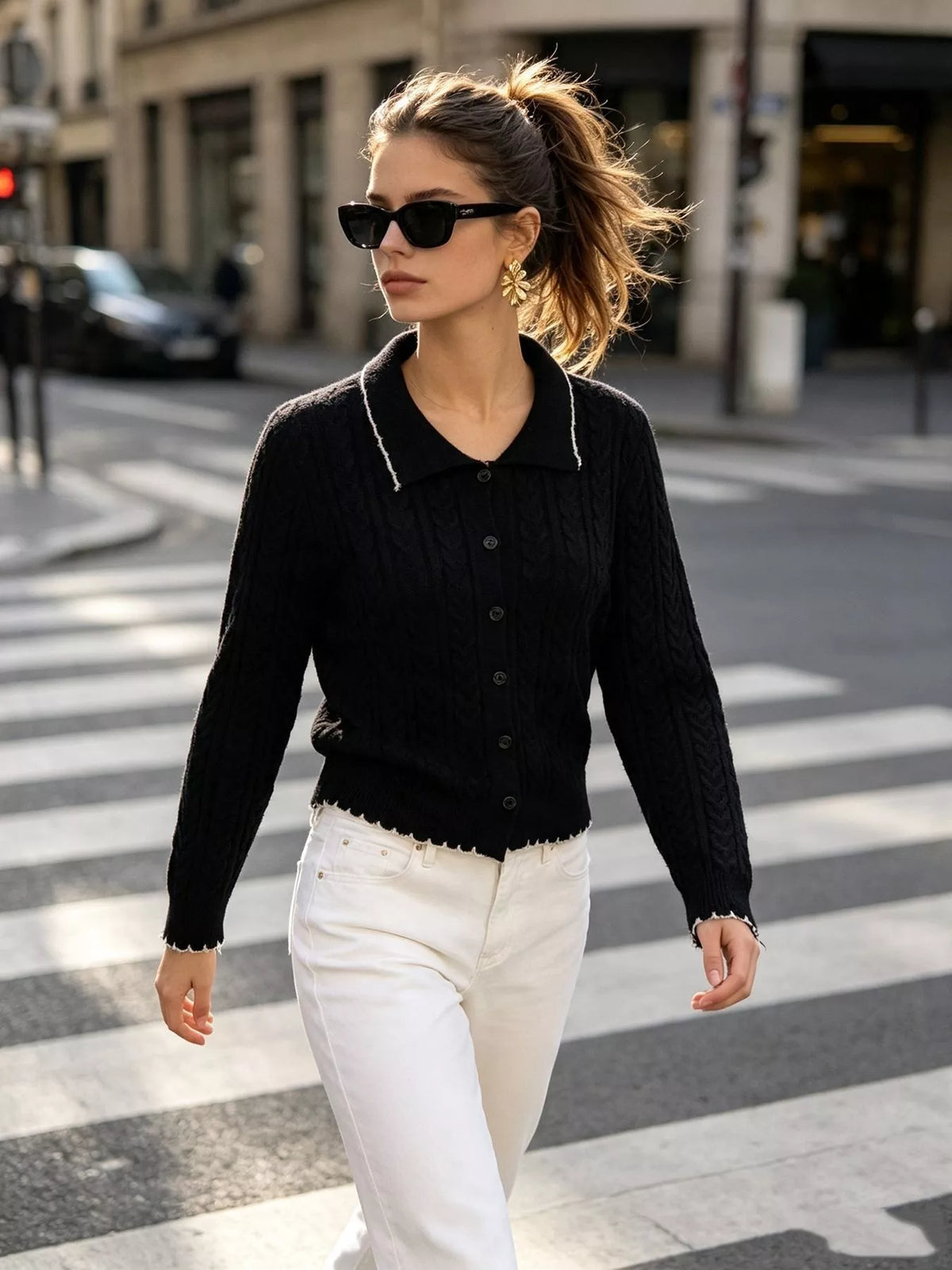 Black cable-knit polo-collar cardigan, full front view.