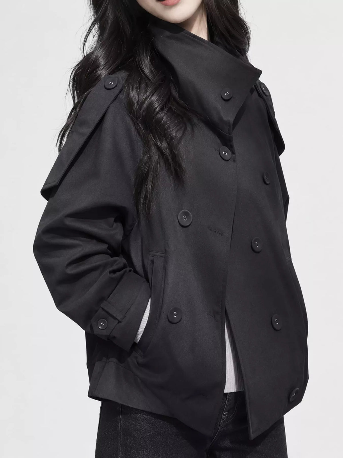 Black double-breasted cropped trench jacket, side view