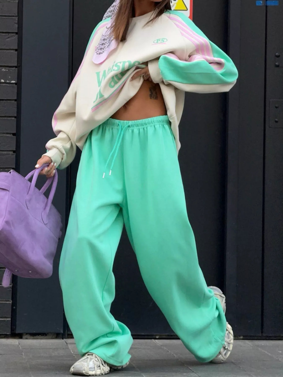 Cream top and green pants color-block sweatshirt and wide-leg pants set — front view